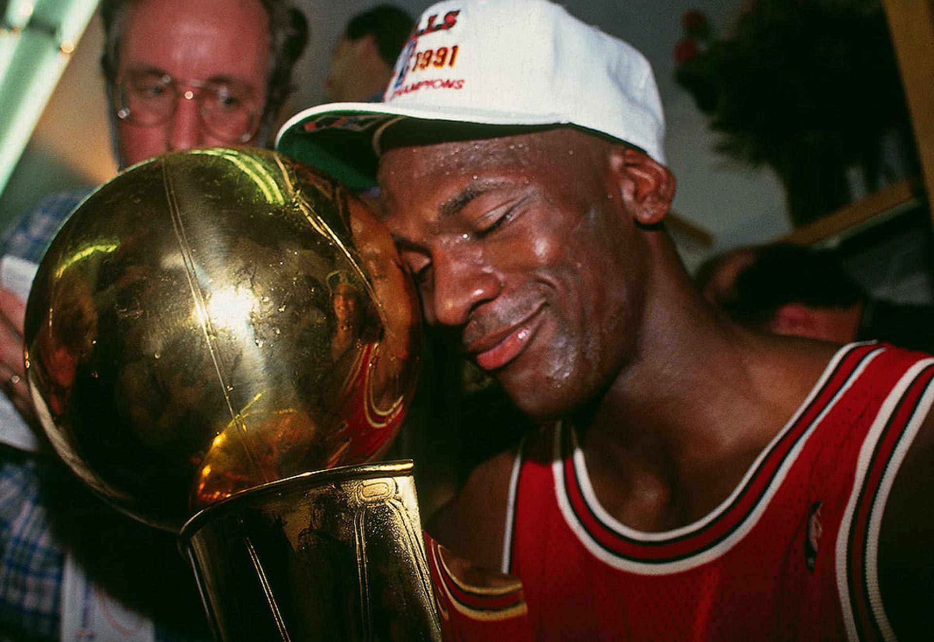 michael jordan smiling and holding larry o'brien trophy